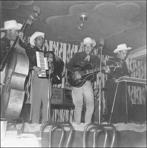 marshall lytle on vocals and acoustic guitar and bill haley on slap bass